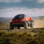 Renault Racoon concept car driving through rugged terrain, showcasing its off-road capabilities