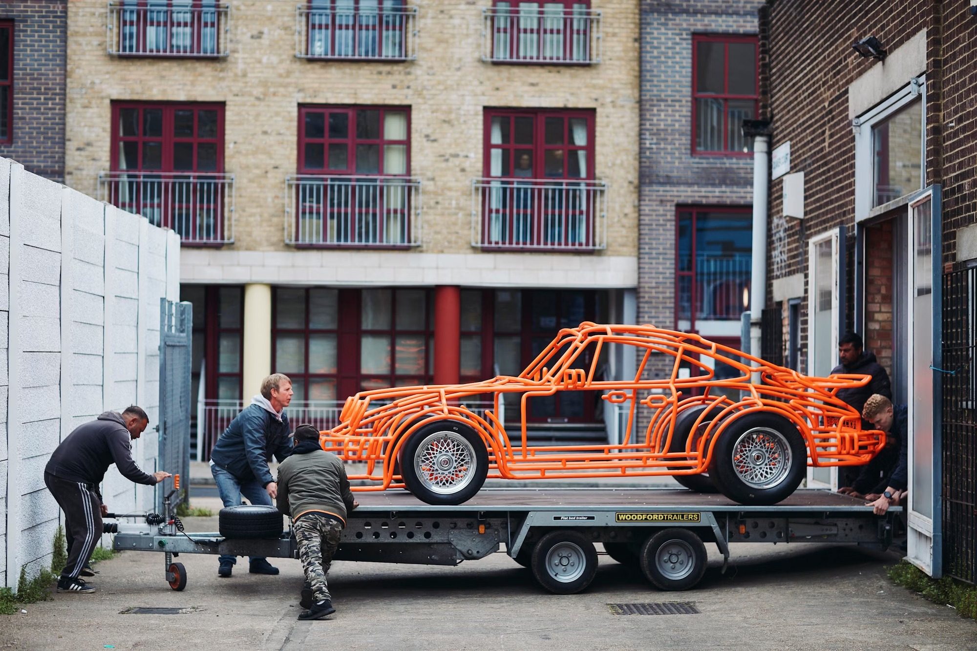The Avon tires mounted on the steel sculpture, emphasizing its authentic racing heritage.