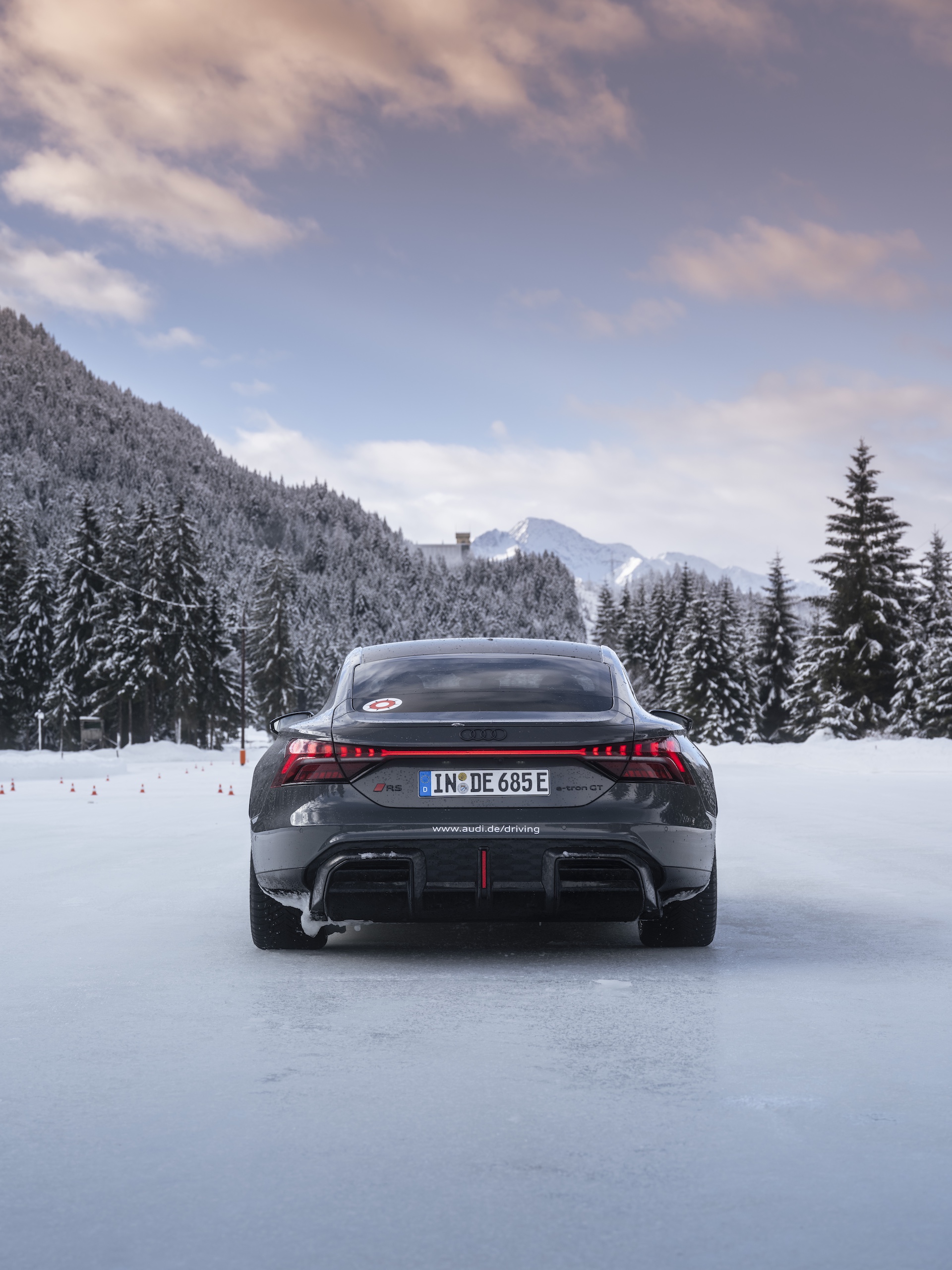 Foot quickly stomping on the throttle to initiate a slide on an icy surface.