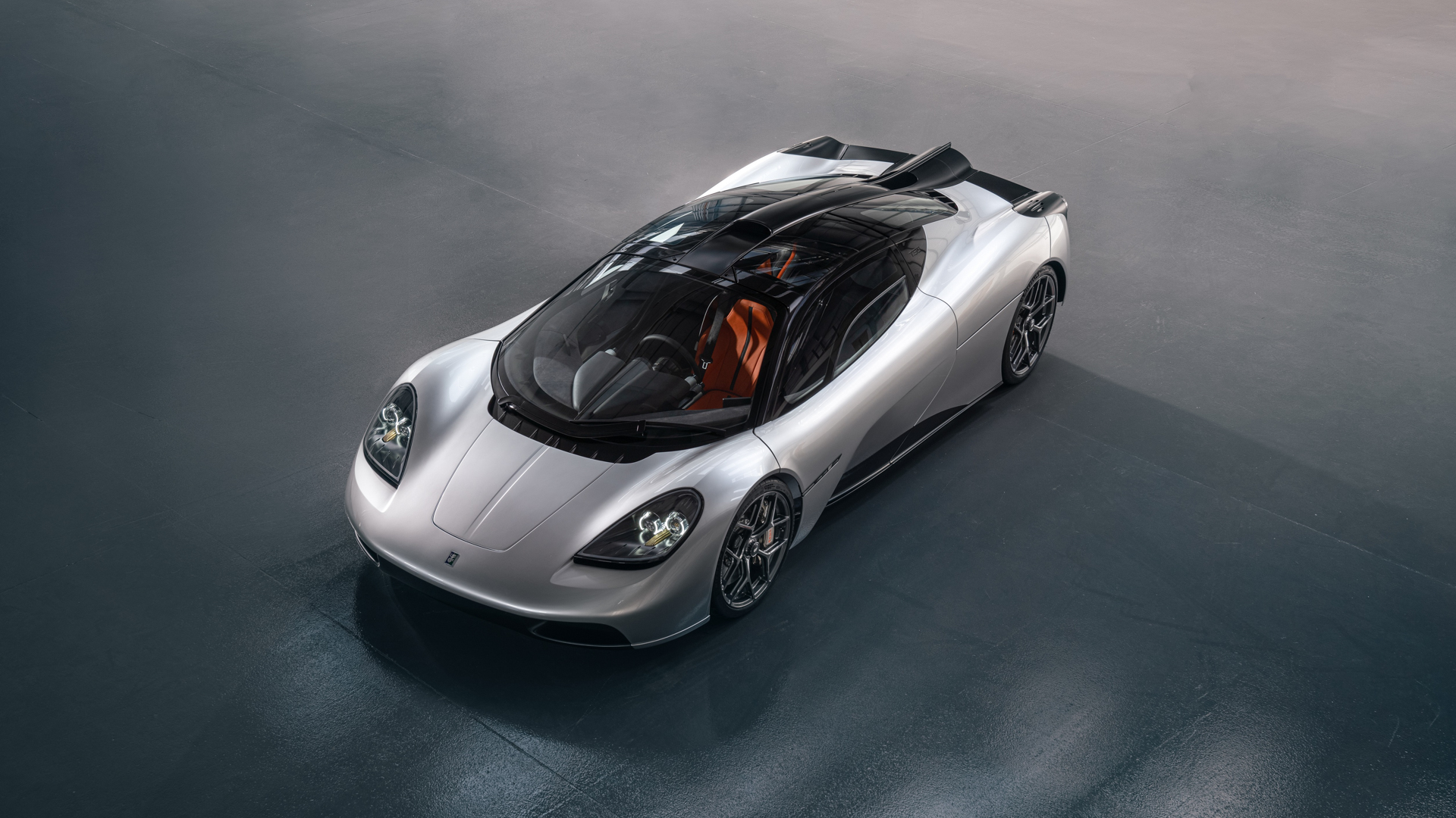 Close-up view of the McLaren F1's carbon fiber chassis and ground effect design, highlighting its technical advancements
